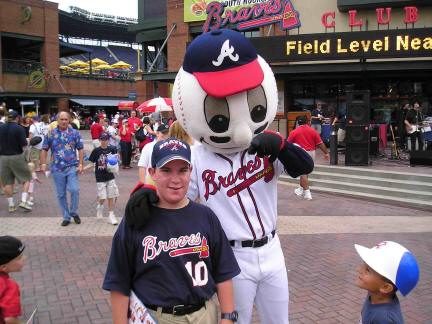 Homer, the Atlanta Braves mascot walks the field during a game